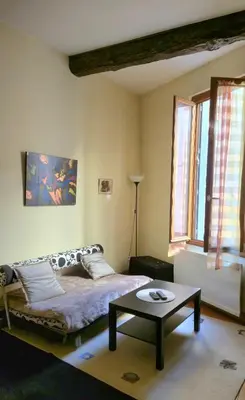 a living room with a bed and a window at Appartement cosy et silencieux avec salon & chambre & mezzanine - 3 couchages - en plein centre historique et proche transports in Aix-en-Provence