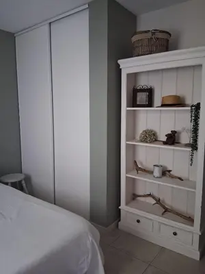 a bedroom with a bed and a white cabinet at AAD maison de vacances avec piscine in LʼIsle-sur-la-Sorgue