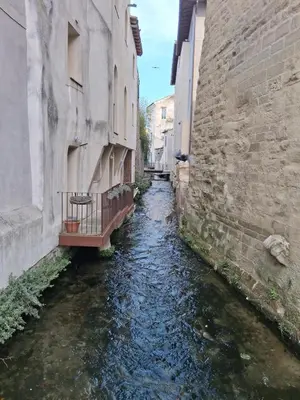 a canal in an alley between two buildings at AAD maison de vacances avec piscine in LʼIsle-sur-la-Sorgue