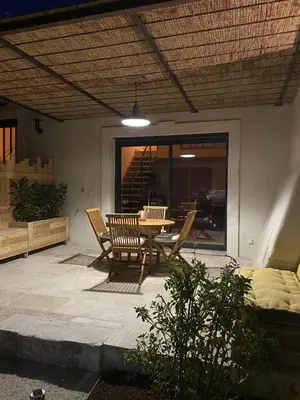 a patio with a table and chairs on a patio at Mas Saint André 3 étoiles au cœur de la Provence in Saint-Andiol