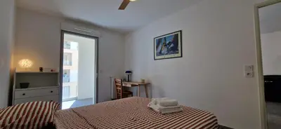 a bedroom with a bed with towels on it at Le Triton, new appartments near city center , parking , lift in Aix-en-Provence