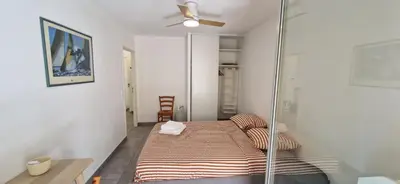 a bedroom with a bed and a ceiling fan at Le Triton, new appartments near city center , parking , lift in Aix-en-Provence