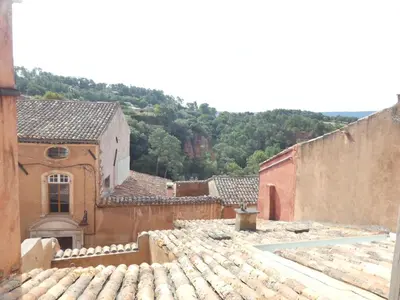 a view of a village with buildings and roofs at La Cachette centre historique village in Roussillon