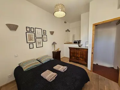 a bedroom with a bed with two towels on it at Le nid douillet in Pertuis