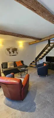 a living room with a couch and chairs and a piano at Le nid douillet in Pertuis