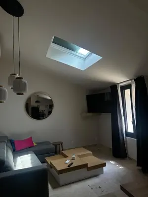 a living room with a couch and a mirror at Le Fort 6 - Appartement neuf 6p in LʼIsle-sur-la-Sorgue