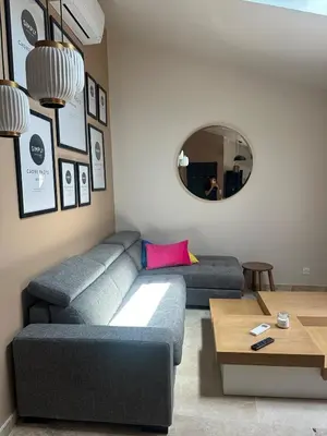 a living room with a couch and a table at Le Fort 6 - Appartement neuf 6p in LʼIsle-sur-la-Sorgue