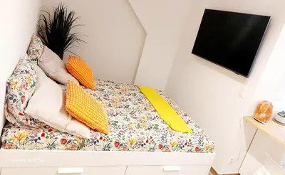 a bed with pillows on top of it in a room at Studio MAREVA in Cavaillon