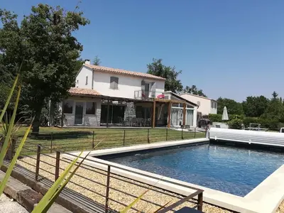 a house with a swimming pool in front of a house at Maison Luberon piscine in Viens