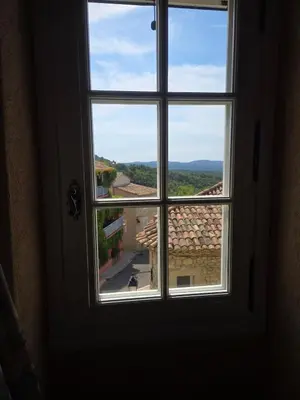 an open window with a view of a street at Appartement Gîte d'Etape Vitrolles en Luberon in Vitrolles-en-Luberon