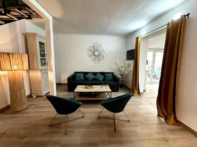 a living room with a couch and chairs and a table at T2 à 5mn à pieds du Cours Mirabeau in Aix-en-Provence