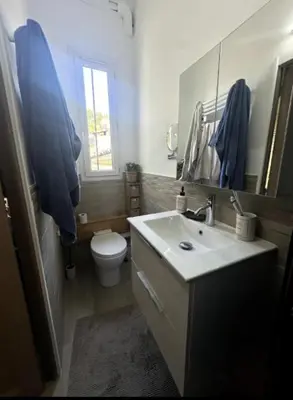 a bathroom with a sink and a toilet and a mirror at T2 à 5mn à pieds du Cours Mirabeau in Aix-en-Provence