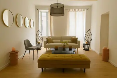 a living room with a couch and a table and chairs at CARPENTRAS 2ème étage BEL APPARTEMENT au CENTRE VILLE in Carpentras