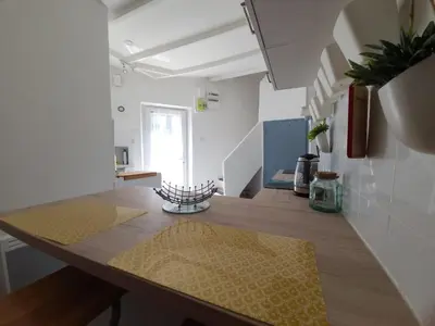 a kitchen with a counter with a yellow rug on it at Village House in Pélissanne near Luberon in Pélissanne