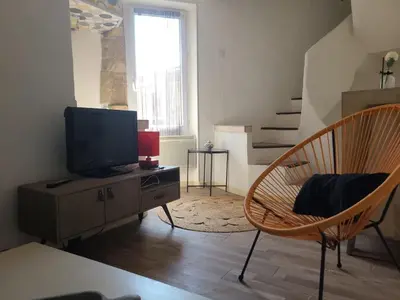 a living room with a tv and a chair at Village House in Pélissanne near Luberon in Pélissanne