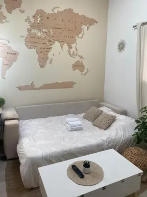 a bedroom with a bed with a world map on the wall at Tiny House - Les Baïsses - Jardin Tropical in Lançon-Provence