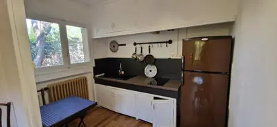a table and chairs in a house with a table and a door at Family house in town centre 8 guest AC FreeParking in Aix-en-Provence