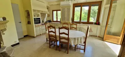 a kitchen with a table and chairs in a room at Family house in town centre 8 guest AC FreeParking in Aix-en-Provence