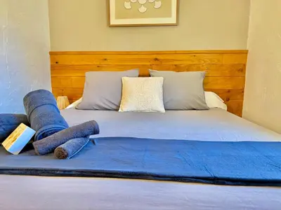 a bed with blue blankets and pillows on it at Refuge reposant - Centre ville - Espace Bureau in Aix-en-Provence