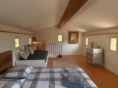 a bedroom with two beds and a dresser at Bastidon avec vue et piscine au coeur du Luberon in Céreste