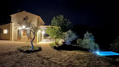 a house lit up at night with a street light at Bastidon avec vue et piscine au coeur du Luberon in Céreste