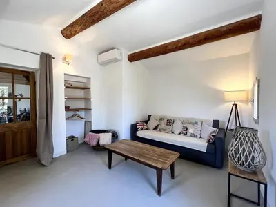 a living room with a blue couch and a table at Bastidon avec vue et piscine au coeur du Luberon in Céreste
