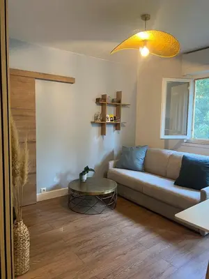 a living room with a couch and a table at T2 Aurélia in Aix-en-Provence
