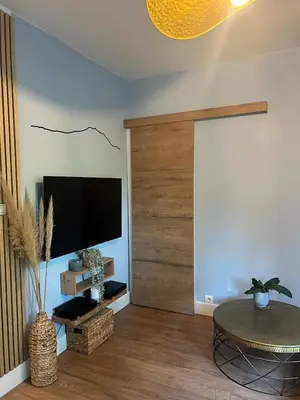 a living room with a flat screen tv and a table at T2 Aurélia in Aix-en-Provence