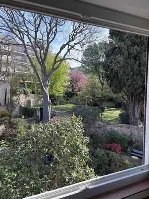 a view of a garden through a window at T2 Aurélia in Aix-en-Provence