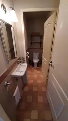 a bathroom with a toilet and a sink and a mirror at Les Carrairades in Mollégès