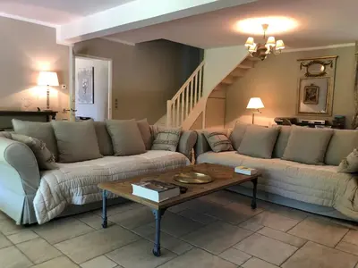 a living room with two couches and a coffee table at Les Carrairades in Mollégès