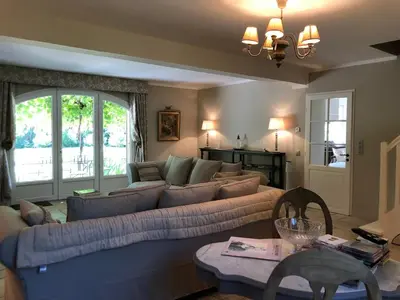 a living room with a large couch and a table at Les Carrairades in Mollégès