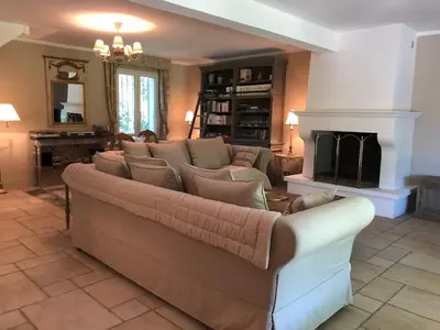 a living room with a couch and a fireplace at Les Carrairades in Mollégès