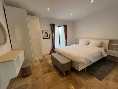 a bedroom with a white bed and a window at House with a view of Luberon and a pool in Maubec