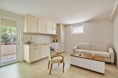 a kitchen and living room with a couch and a table at Appartment 5 min walking from city center in Aix-en-Provence