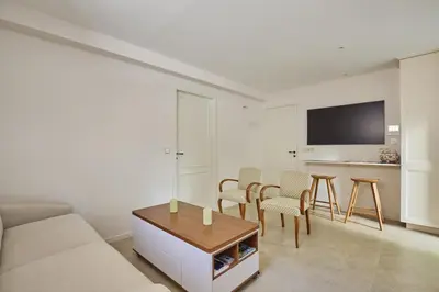 a living room with a couch and a table and chairs at Appartment 5 min walking from city center in Aix-en-Provence