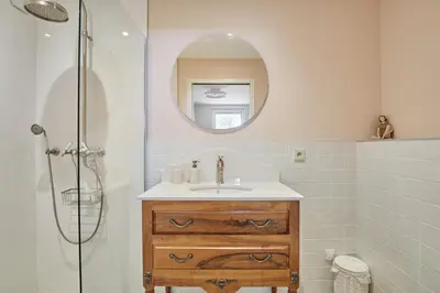 a bathroom with a sink and a shower with a mirror at Appartment 5 min walking from city center in Aix-en-Provence