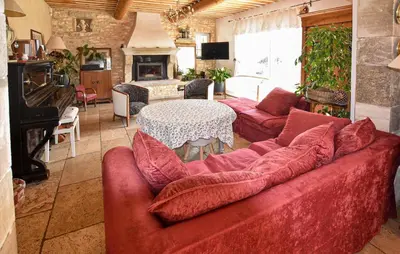 a living room with a red couch and a table at Maison Avec Piscine Privée in Lacoste