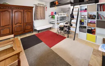 a living room with a red white and black rug at Maison Avec Piscine Privée in Lacoste