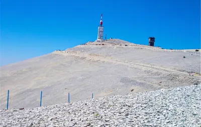 a hill with a lighthouse on top of it at Maison Avec Piscine Privée in Lacoste