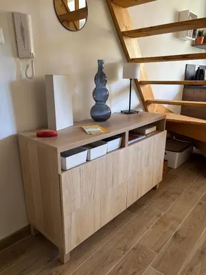 a wooden dresser in a room with a staircase at Studio charmant centre historique au calme in Aix-en-Provence