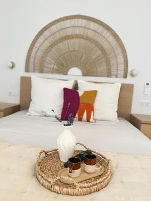 a tray with a vase and cups on a bed at Le Quatre Relax in Aix-en-Provence