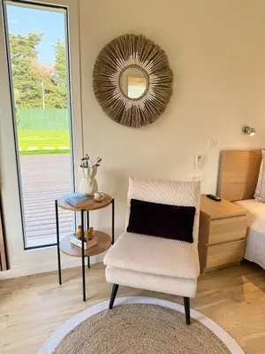 a bedroom with a chair and a mirror and a bed at Cozy studio with air conditioning & pool & parking in Aix-en-Provence