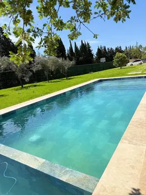 a swimming pool with blue water in a yard at Cozy studio with air conditioning & pool & parking in Aix-en-Provence