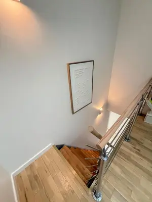 a staircase with a painting on the wall and a picture at Escapade Provençale 5 in Aix-en-Provence