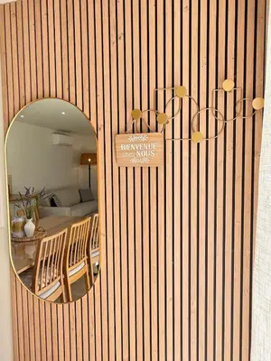 a mirror on the wall of a room with a bedroom at Appartement Confortable en Provence in Aix-en-Provence