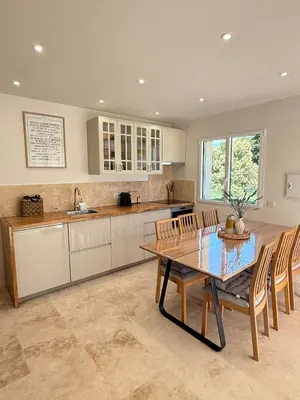 a kitchen with a table and chairs and a sink at Appartement Confortable en Provence in Aix-en-Provence