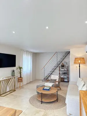 a living room with a couch and a table at Appartement Confortable en Provence in Aix-en-Provence
