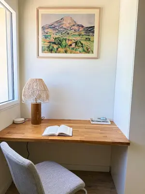 a desk with a lamp and two books on it at Appartement Confortable en Provence in Aix-en-Provence