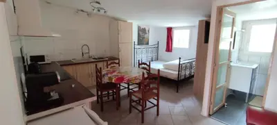 a kitchen and dining room with a table and chairs at le Jardin de Flore in Manosque